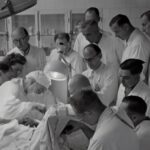 Robotic Arms - photography of people watching watching operation inside room