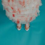 Recycled Materials - person wearing brown-and-white lace-up shoes