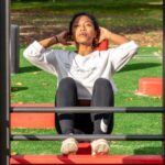 High-strength Markets - woman in white long sleeve shirt and black pants sitting on red metal frame