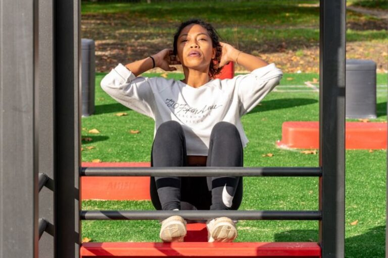High-strength Markets - woman in white long sleeve shirt and black pants sitting on red metal frame