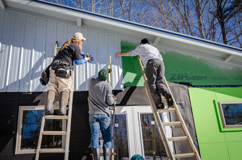 Residential Construction - three person climbing on ladder