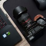 Consumer Electronics - black camera lens on black laptop computer