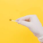 Tube Packaging - person holding white cotton buds