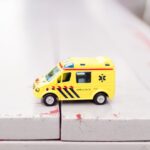 Surface Treatment - yellow car toy on white surface