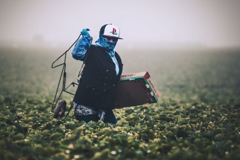 Labor Shortages - man in blue jacket wearing white helmet standing on green grass field during daytime