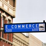 E-commerce - a traffic light with a street sign hanging from it's side