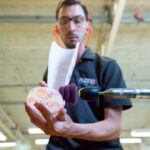 Forming Tools - man in black polo shirt holding pink and white floral ceramic mug