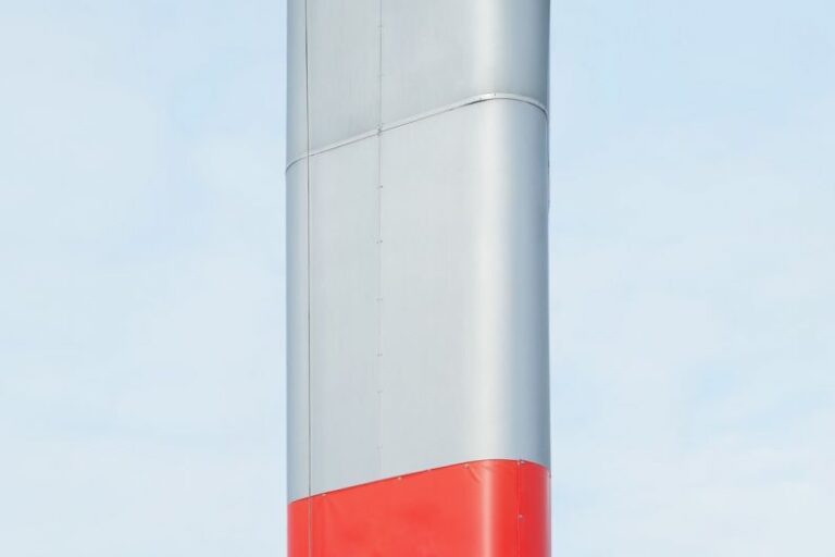 Clean Machinery - a red and white pole against a blue sky