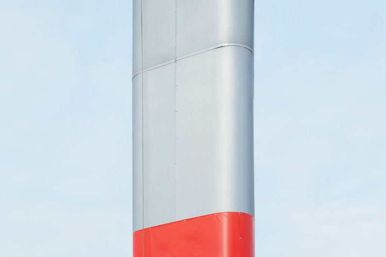 Clean Machinery - a red and white pole against a blue sky