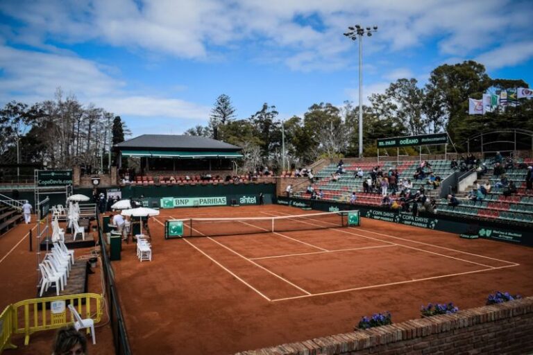 Maintenance Challenges - a tennis court with a crowd of people watching it
