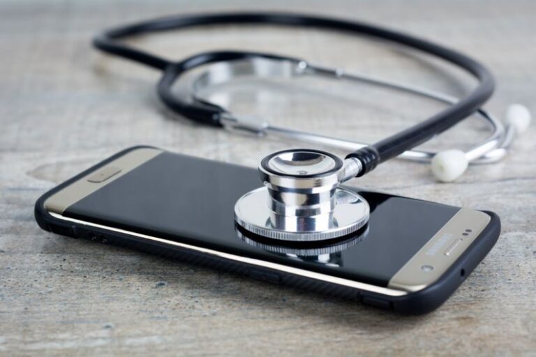 Troubleshooting - a smart phone with a stethoscope on top of it