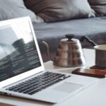 Remote Monitoring - turned on MacBook Air beside black smartphone and black ceramic mug