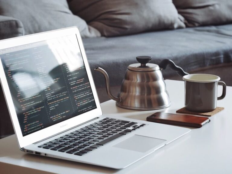 Remote Monitoring - turned on MacBook Air beside black smartphone and black ceramic mug