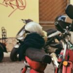 Beveling Machine - a red scooter parked next to a yellow building