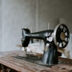 Deburring Machine - black sewing machine on brown wooden table