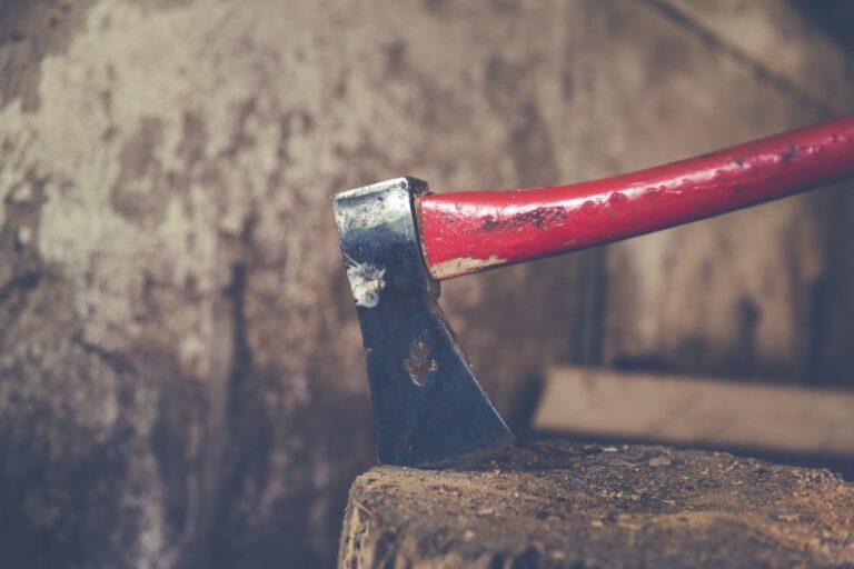 Multi-material - red and black axe on wood slab