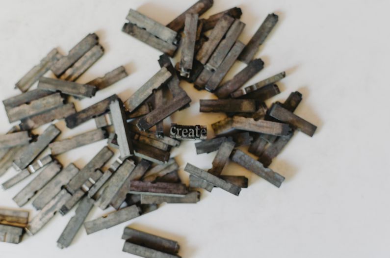 Hydraulic Press - closeup photo of clothespin lot on white surface
