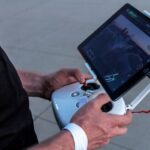 Wireless Monitoring - person holding quadcopter controller