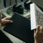 CAD/CAM - a man looking at a piece of art on a table