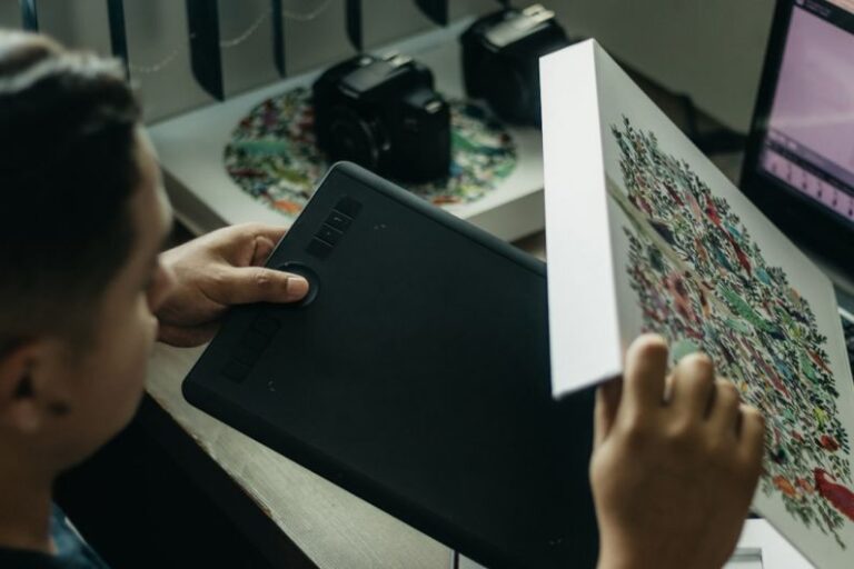 CAD/CAM - a man looking at a piece of art on a table