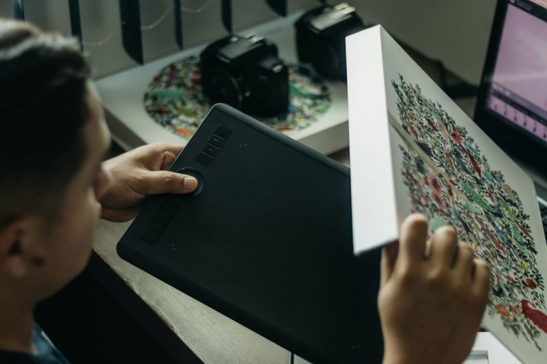 CAD/CAM - a man looking at a piece of art on a table
