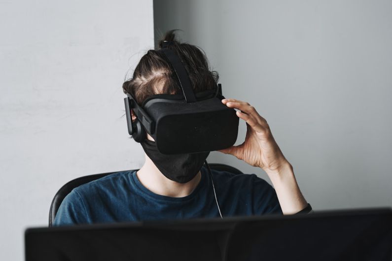 AI Defect Detection - man in blue crew neck shirt wearing black vr goggles