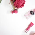 Tube Polishing - red rose beside clear perfume bottle