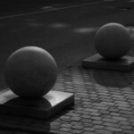 Surface Coating - a couple of large balls sitting on top of cement blocks