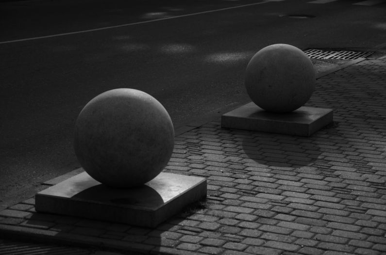 Surface Coating - a couple of large balls sitting on top of cement blocks